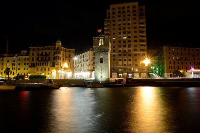 Night view of Savona, Italy waterfront with buildings and tower