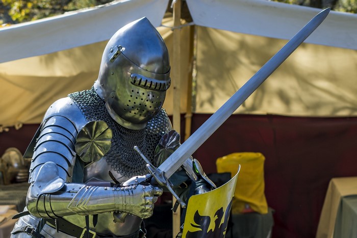 Knight in full armor holding a sword and shield