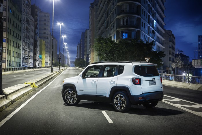 White Jeep Renegade Longitude BR-spec on a city street at night
