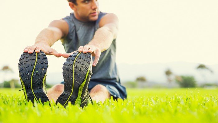 Man stretching on grass