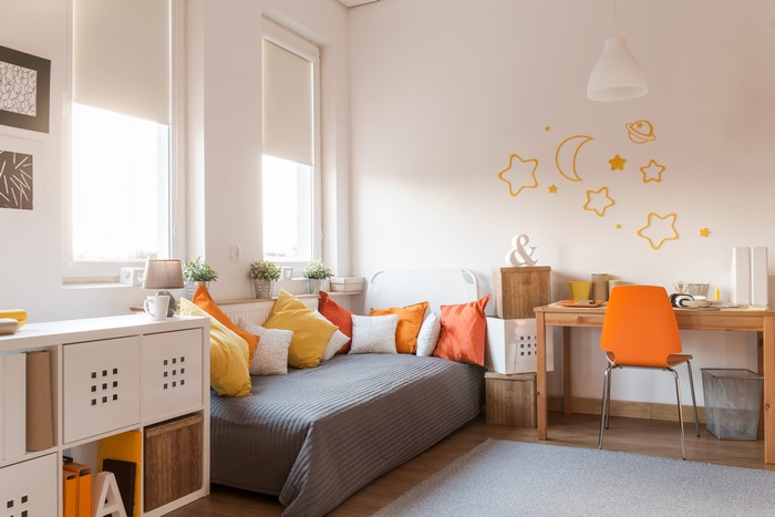 Bedroom with bed, desk, and storage shelves