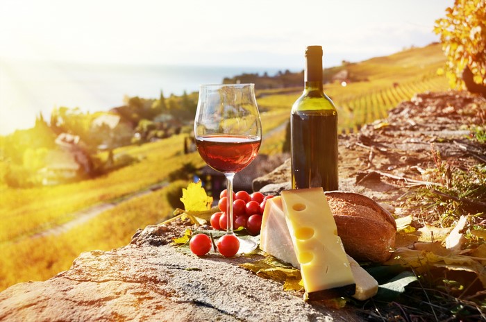 Wine, Grapes, Cheese, and Bread on a Cliffside