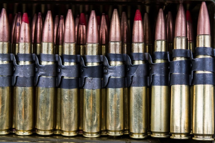 A row of machine gun cartridges in a belt