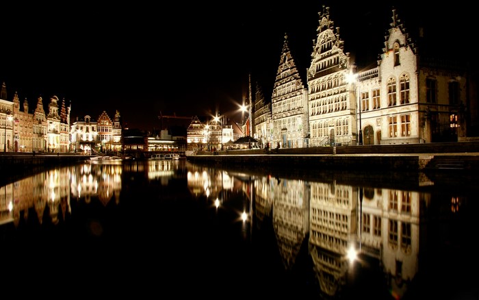 Ghent Belgium canal at night with historic buildings