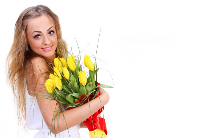 Blonde girl holding yellow tulips