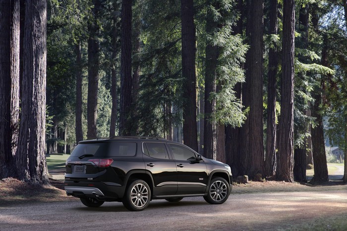 Black GMC Acadia All Terrain in a Forest