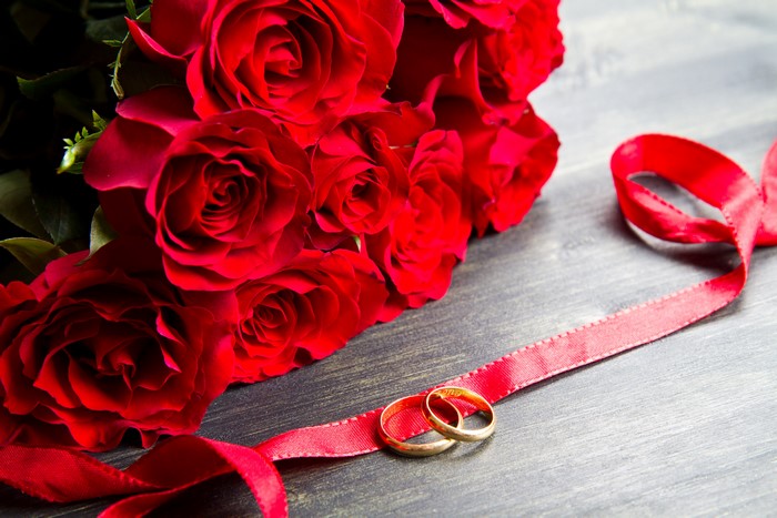 Red Roses with Wedding Rings and Ribbon