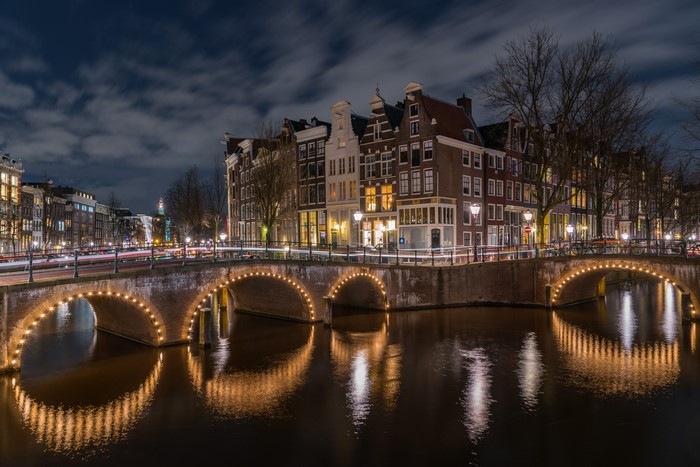 Amsterdam Canal at Night with Bridge and Houses