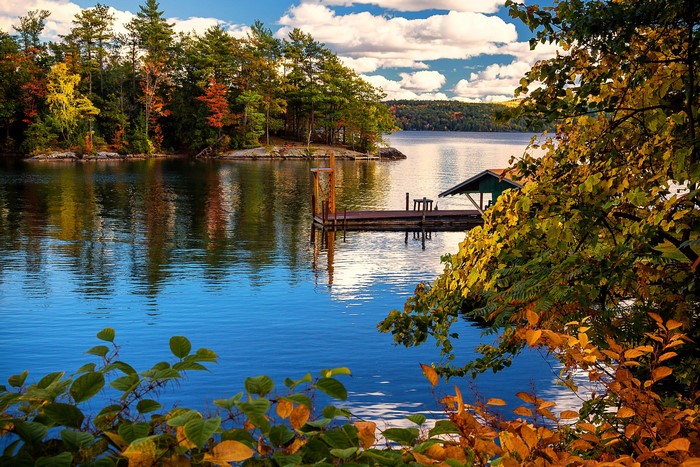 Autumn lake with dock and trees in New York