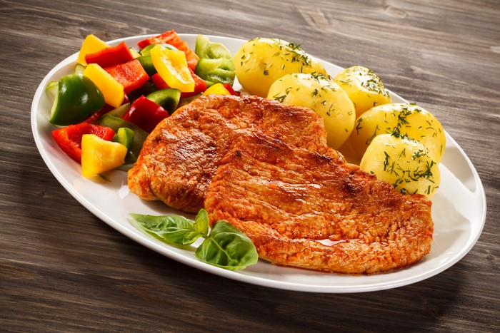 Meat products with potatoes and vegetables on a plate