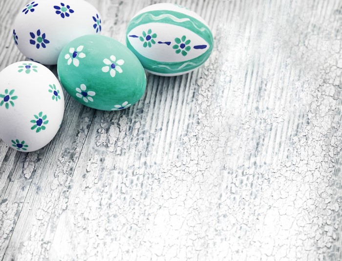 Easter eggs with floral designs on wooden surface