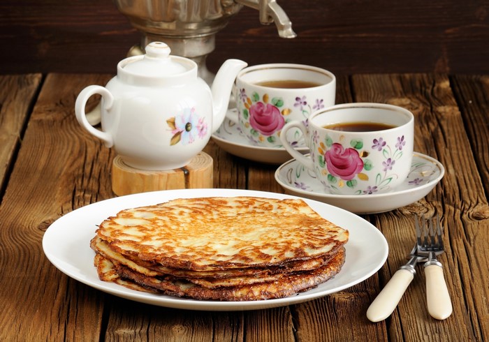 Stack of pancakes with tea and samovar