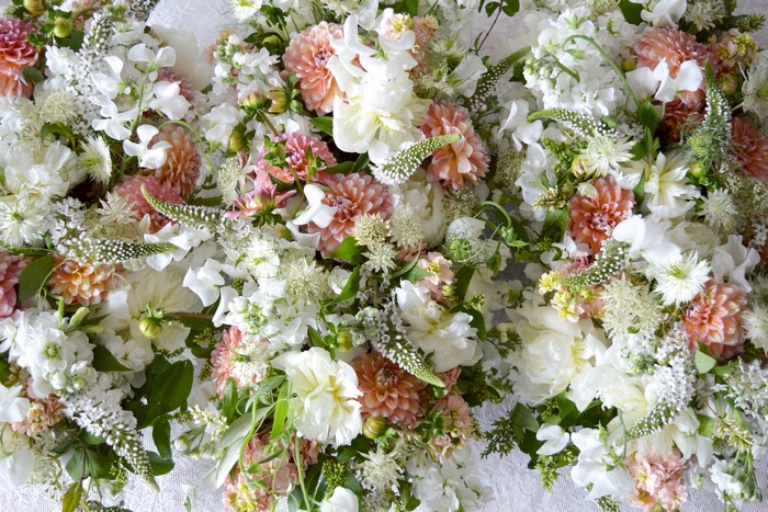A large arrangement of white and pink dahlias and other flowers.