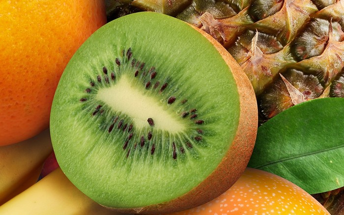 Close-up of a sliced kiwi fruit with other fruits