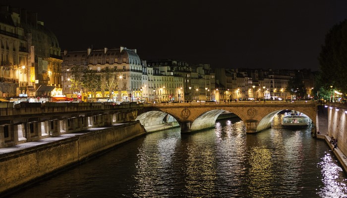 Paris at night with bridge over Seine River