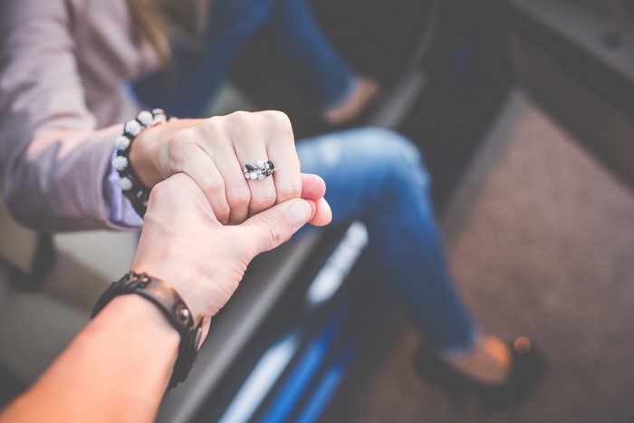Couple holding hands in a car