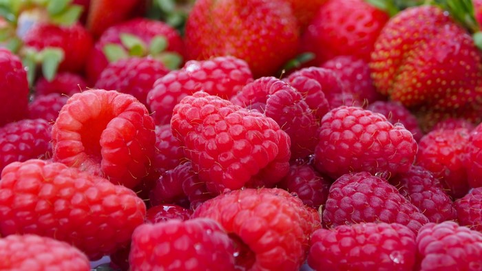 4K Closeup of Many Raspberries and Strawberries