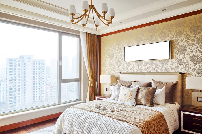 Bedroom with large window and chandelier