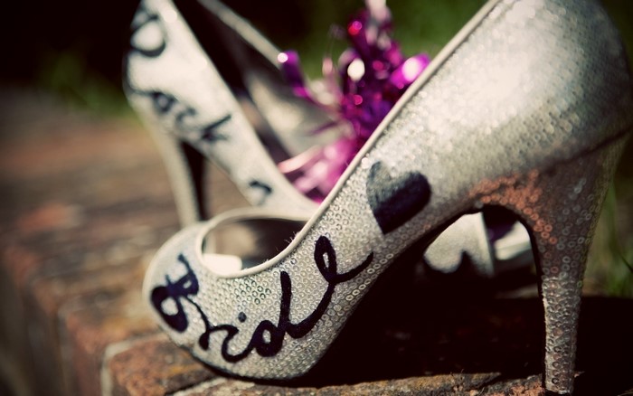 Sparkly silver stiletto heels with 'Bride' written on them