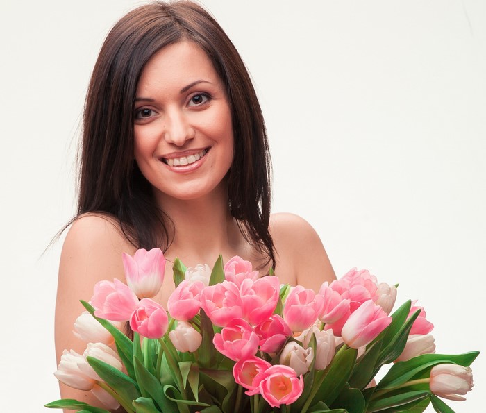 Woman with a bouquet of pink and white tulips