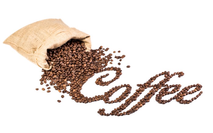 Coffee beans spelling out "Coffee" next to a burlap sack