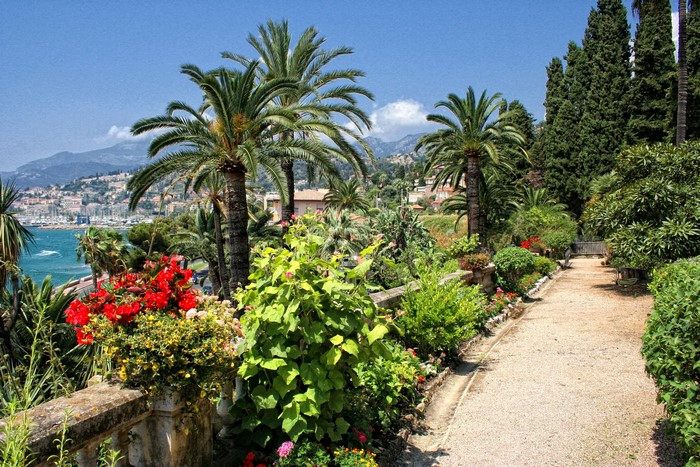 Gardens overlooking Menton, France with palm trees and the sea