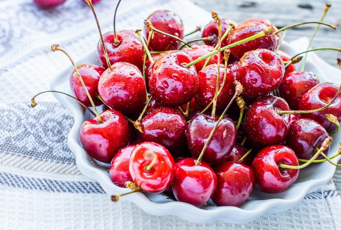 Bowl of fresh cherries with water drops