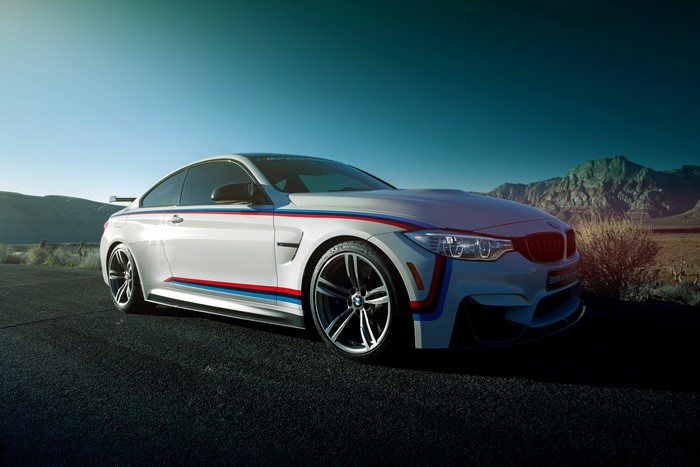 White BMW M4 Coupe with racing stripes