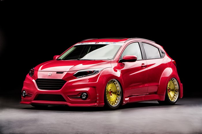 Red Honda HR-V with custom body kit and gold wheels