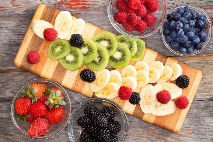 Fruit platter with strawberries, blueberries, raspberries, blackberries, kiwi, and bananas