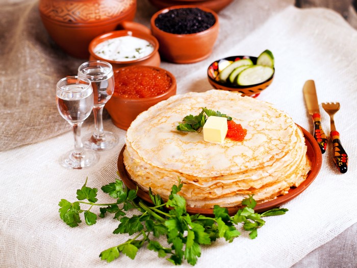 Pancakes with caviar, vodka, and sour cream