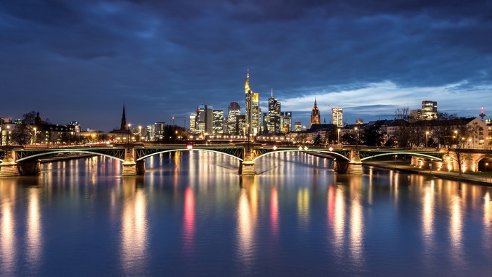 Frankfurt skyline and bridge over river at night