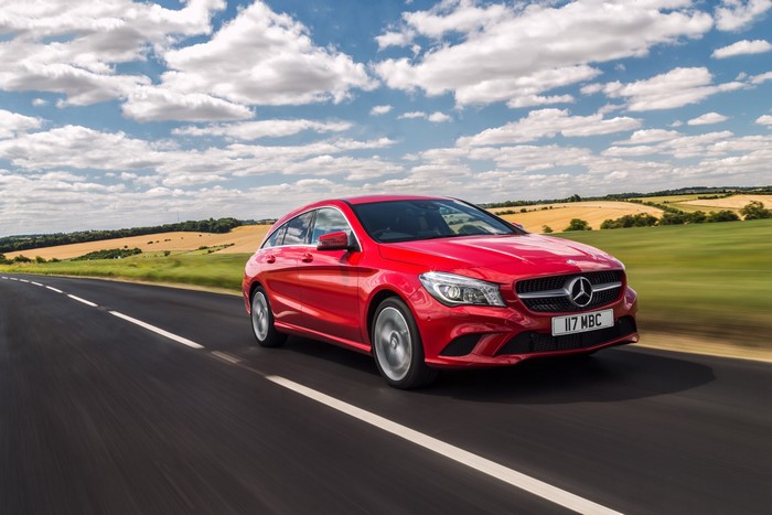 Red Mercedes-Benz CLA-Class X117 driving on a road