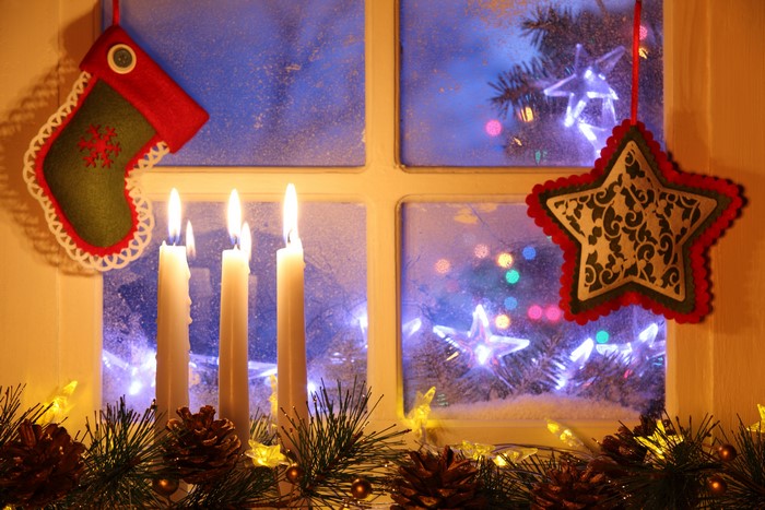 Christmas window with candles and decorations