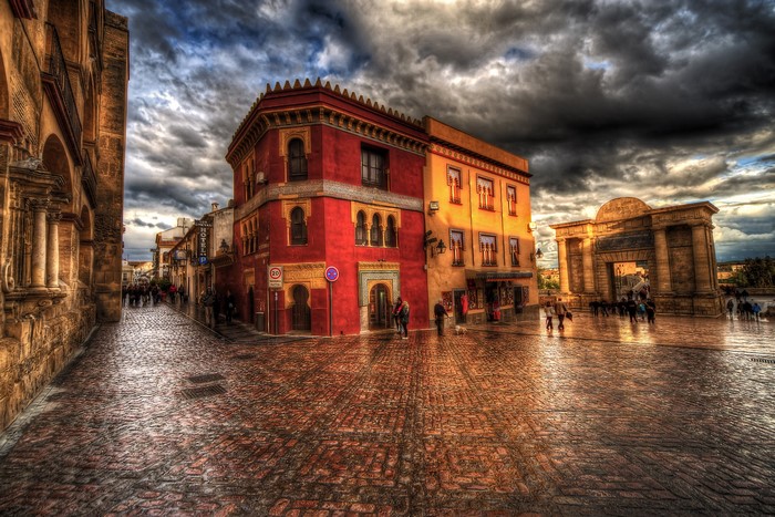 Cordoba street with historic buildings and archway