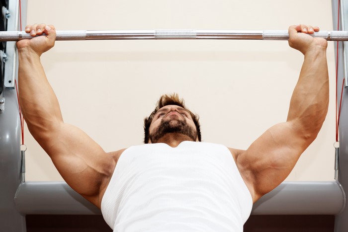 Man lifting barbell in gym