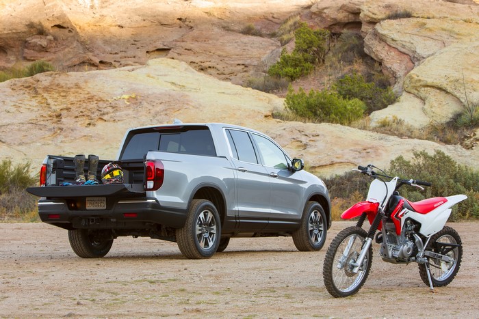 Grey Honda Ridgeline truck with dirt bike and gear