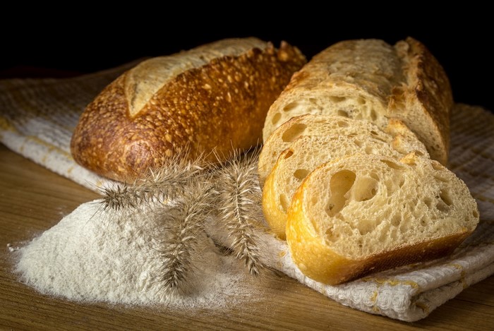 Bread, Flour, and Wheat Ears on a Table