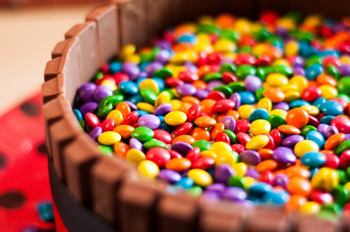 Colorful candies in a chocolate container