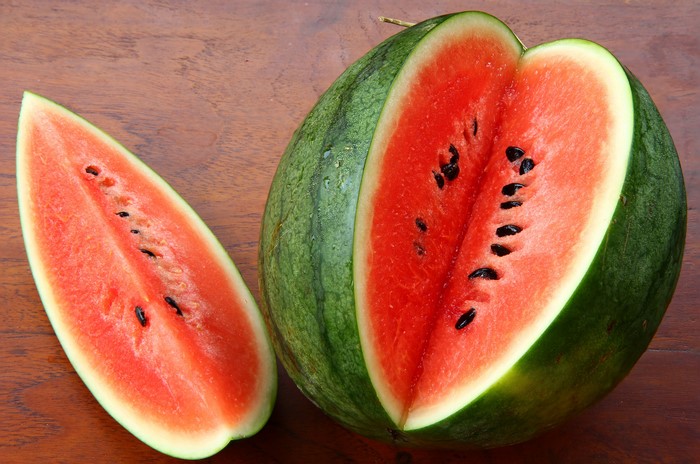 Watermelon pieces on a wooden surface