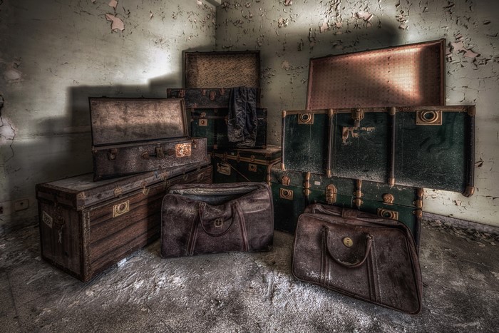 Old suitcases and bags in an abandoned room