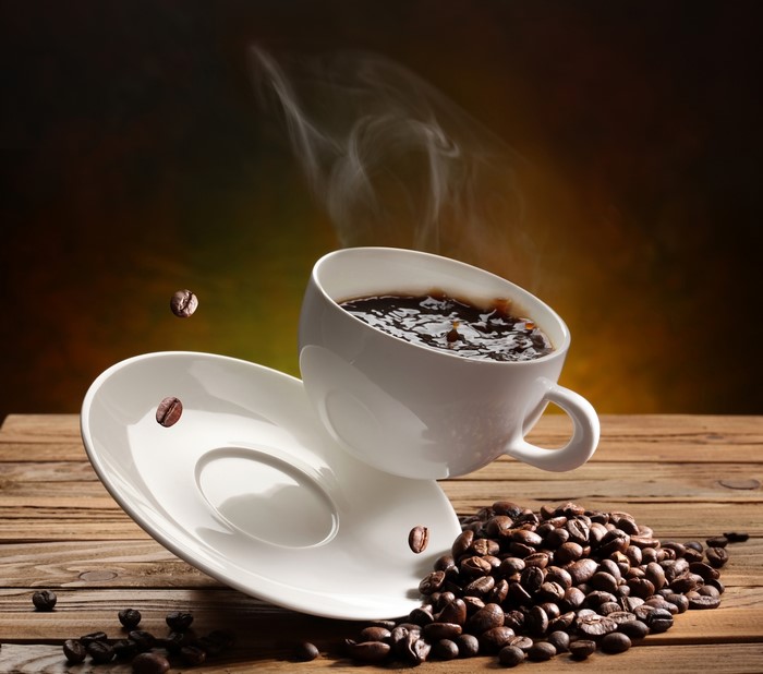 Coffee cup and saucer with coffee beans