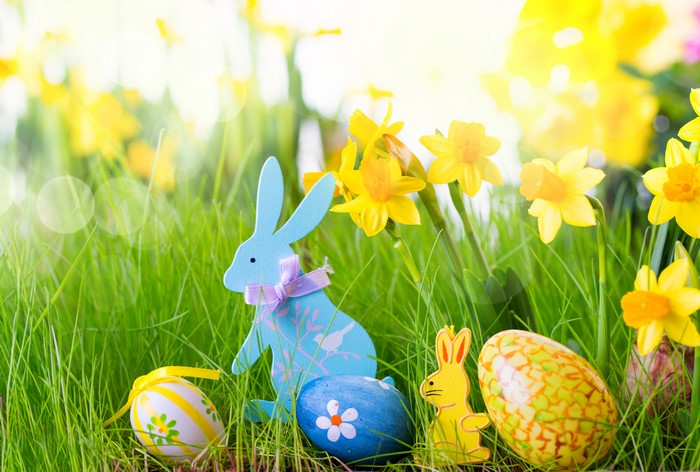 Easter scene with decorated eggs and rabbits in daffodils