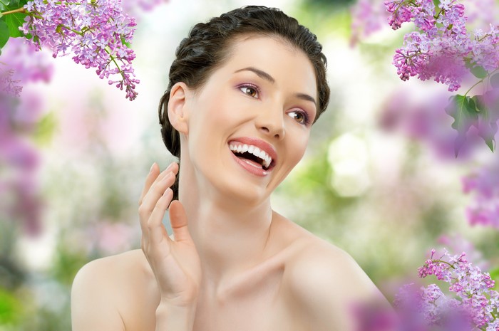Brunette girl with lilac flowers