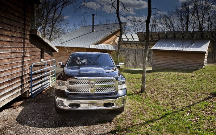 Ram 1500 truck parked near wooden buildings