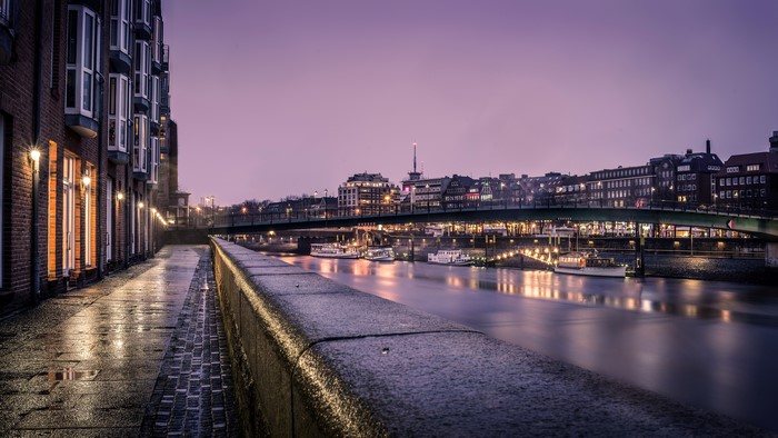 Bremen Germany Riverfront at Night with Bridge and Boats