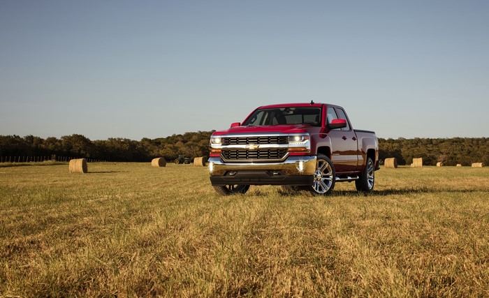 Red Chevrolet Silverado Double Cab Truck in Field