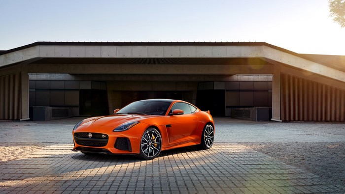 Orange Jaguar F-Type SVR parked in front of a modern building
