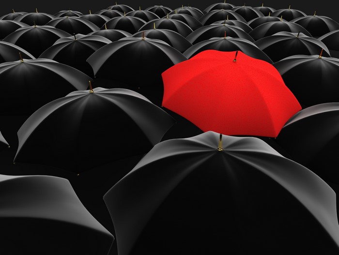 Many umbrellas, one red umbrella