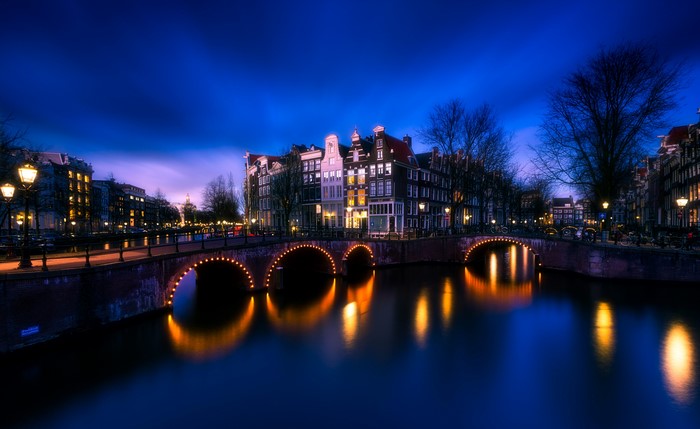 Amsterdam Canal at Night with Bridges and Houses